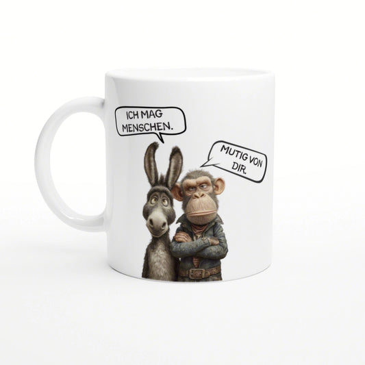 White mug featuring a cartoon donkey and chimpanzee, with speech bubbles reading 'Ich mag Menschen' and 'Mutig von dir'.