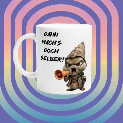 White mug with a cartoon gnome shouting into a megaphone and the slogan Dann mach's doch selber!, on a retro rainbow spiral background.