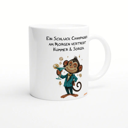 White mug featuring a cartoon monkey in a blue suit holding a cocktail; playful German slogan about champagne and morning.