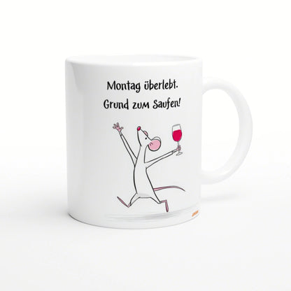 White mug with a cartoon mouse raising a wine glass and the German slogan 'Montag überlebt. Grund zum Saufen!'.
