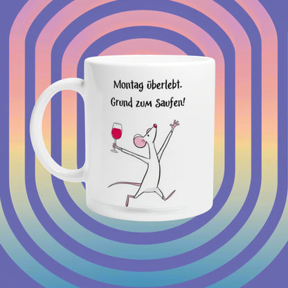 White mug featuring a cartoon mouse with a wine glass and slogan 'Montag überlebt. Grund zum Saufen!' on spiral background.