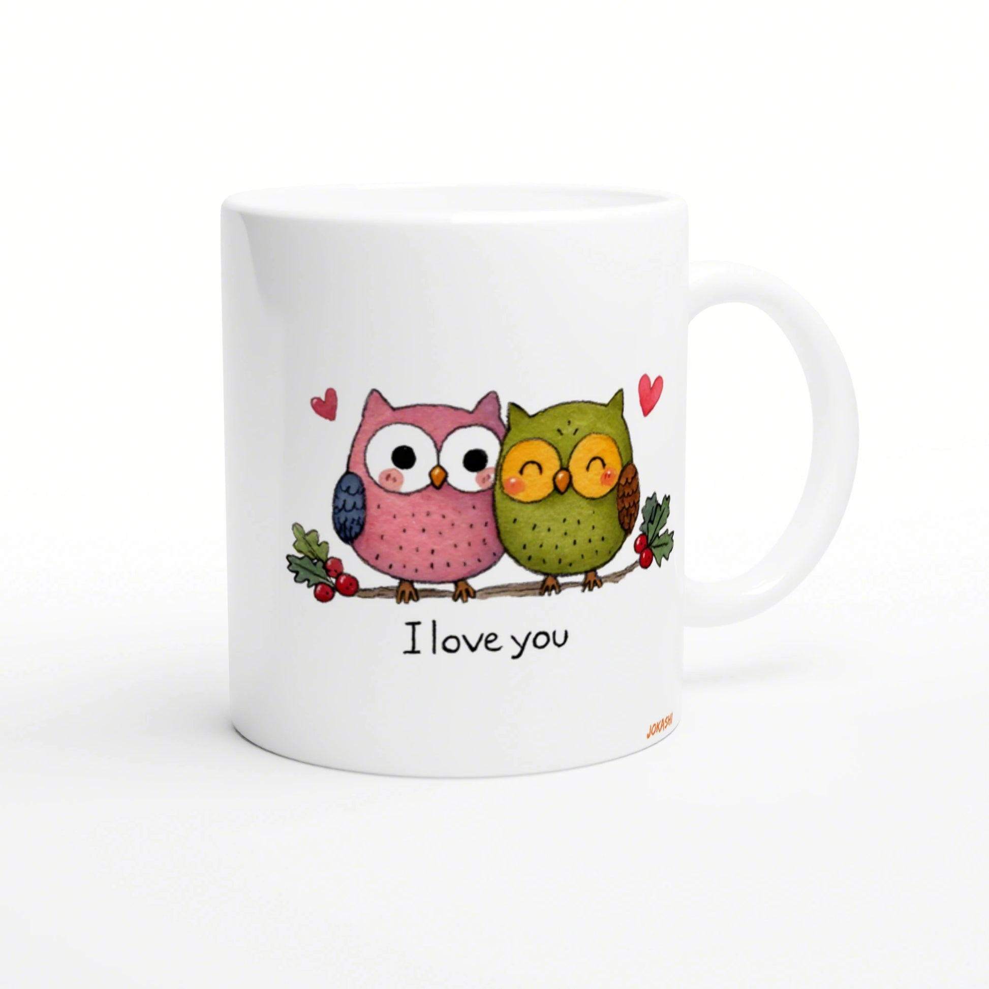 White mug with two cute cartoon owls perched on a branch, small hearts, and the phrase I love you.