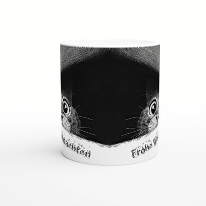 White ceramic mug mockup with a black center panel flanked by two cat faces; decorative text along the bottom edge.