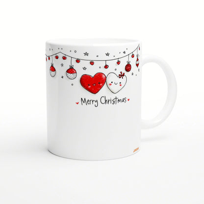 White mug with a hand-drawn Christmas design: red and white heart characters, hanging ornaments, and the text Merry Christmas.