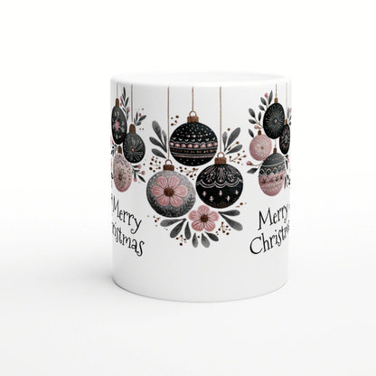 White mug featuring a Christmas ornament motif with hanging black, pink, and gray baubles and 'Merry Christmas' text.