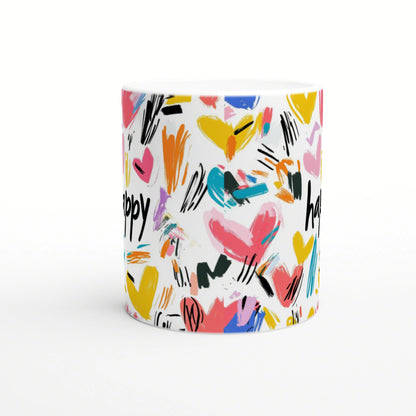 White mug covered with colorful abstract hearts and brush-stroke patterns; a playful product mockup.