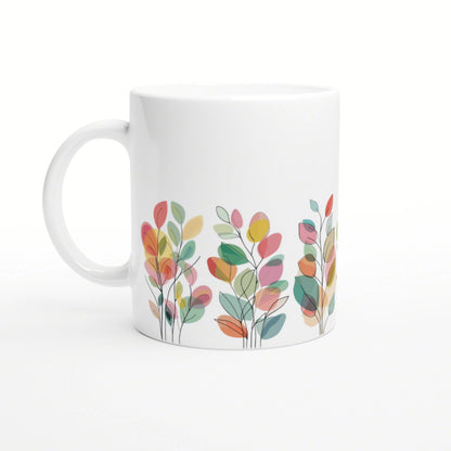 White ceramic mug featuring a colorful abstract leaf pattern along the bottom edge.