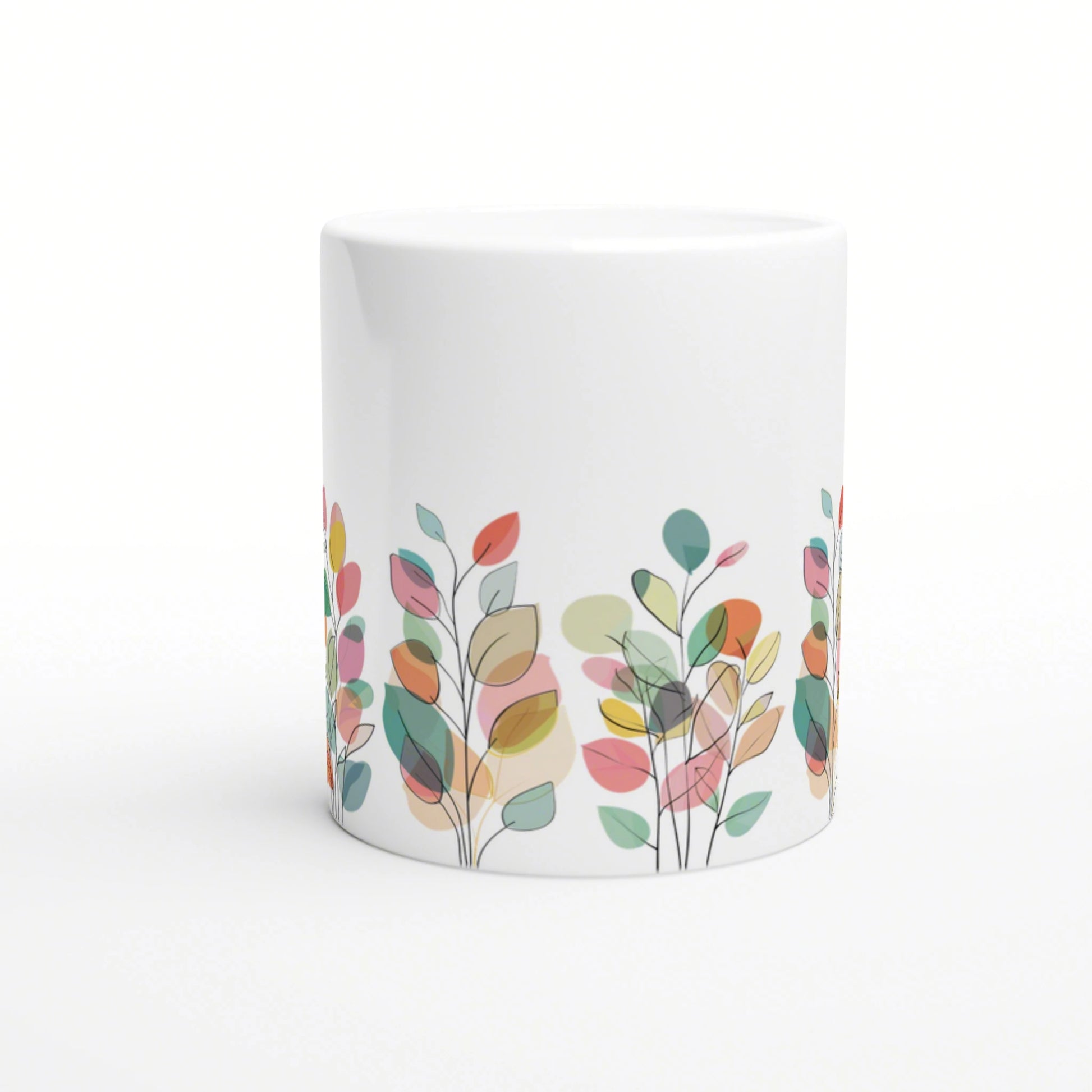 White ceramic mug with a border of multicolored abstract leaves along the bottom edge.