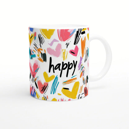Product mockup: white mug covered with colorful brush-stroke hearts and the word happy in bold black at center.