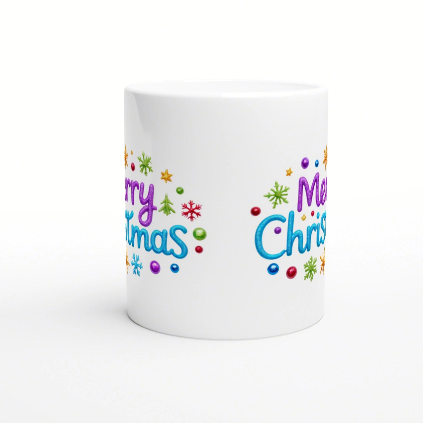 White ceramic mug with a colorful 'Merry Christmas' design, snowflakes and ornaments; product mockup for online shop.