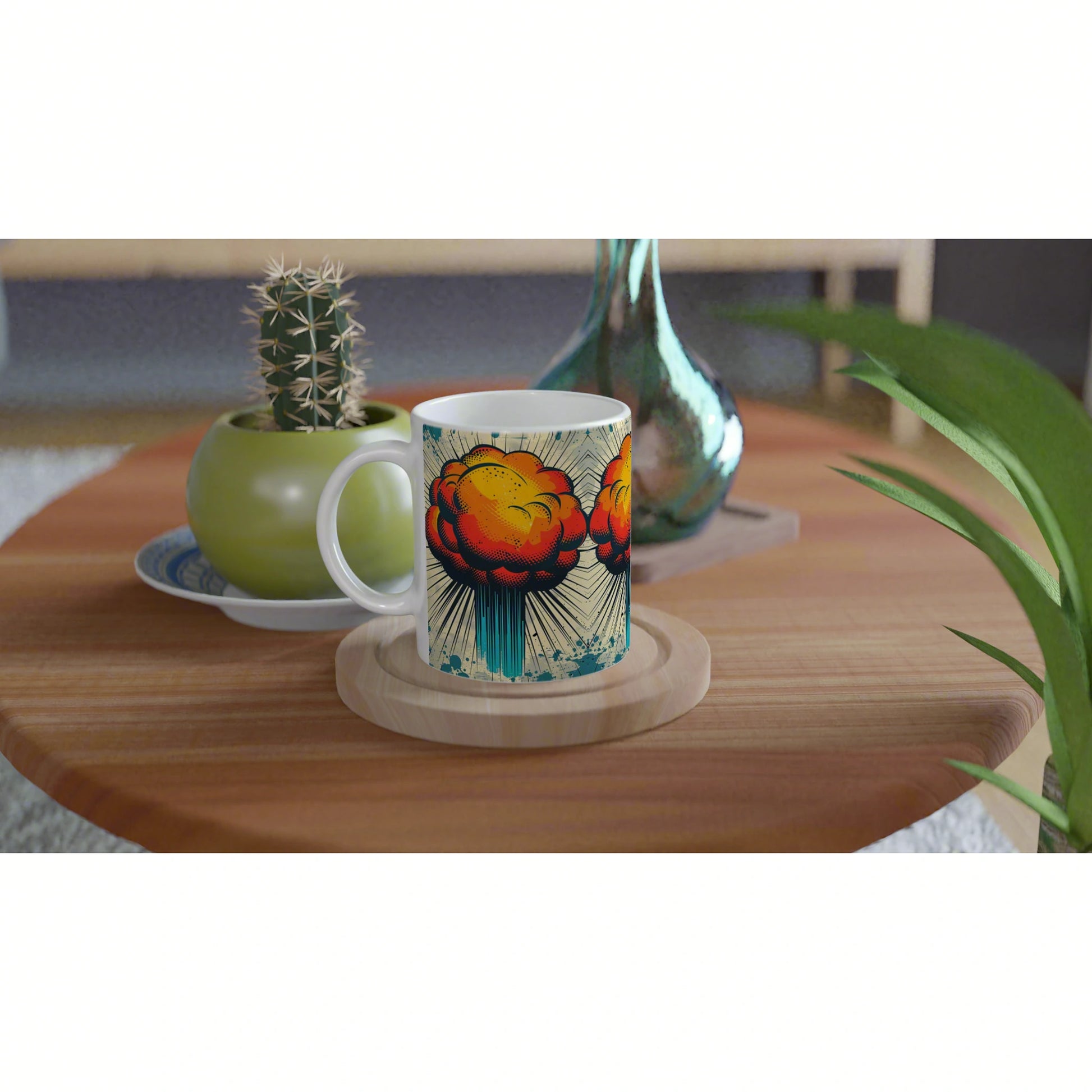 White mug mockup with bold comic-style orange explosion design on a wooden coaster, beside a cactus and teal vase.
