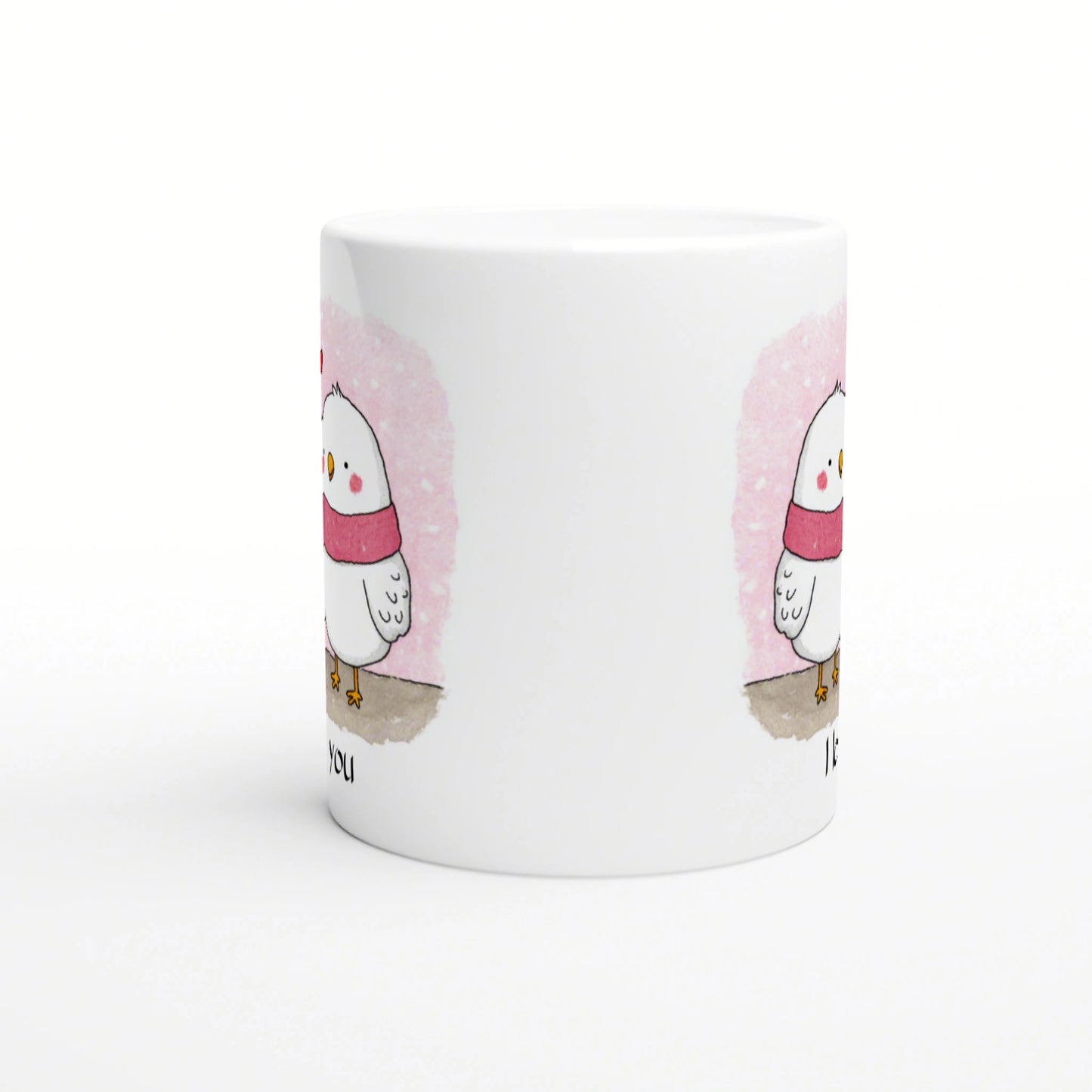 White mug featuring a cute chick wearing a pink scarf against a pink watercolor backdrop; product mockup.
