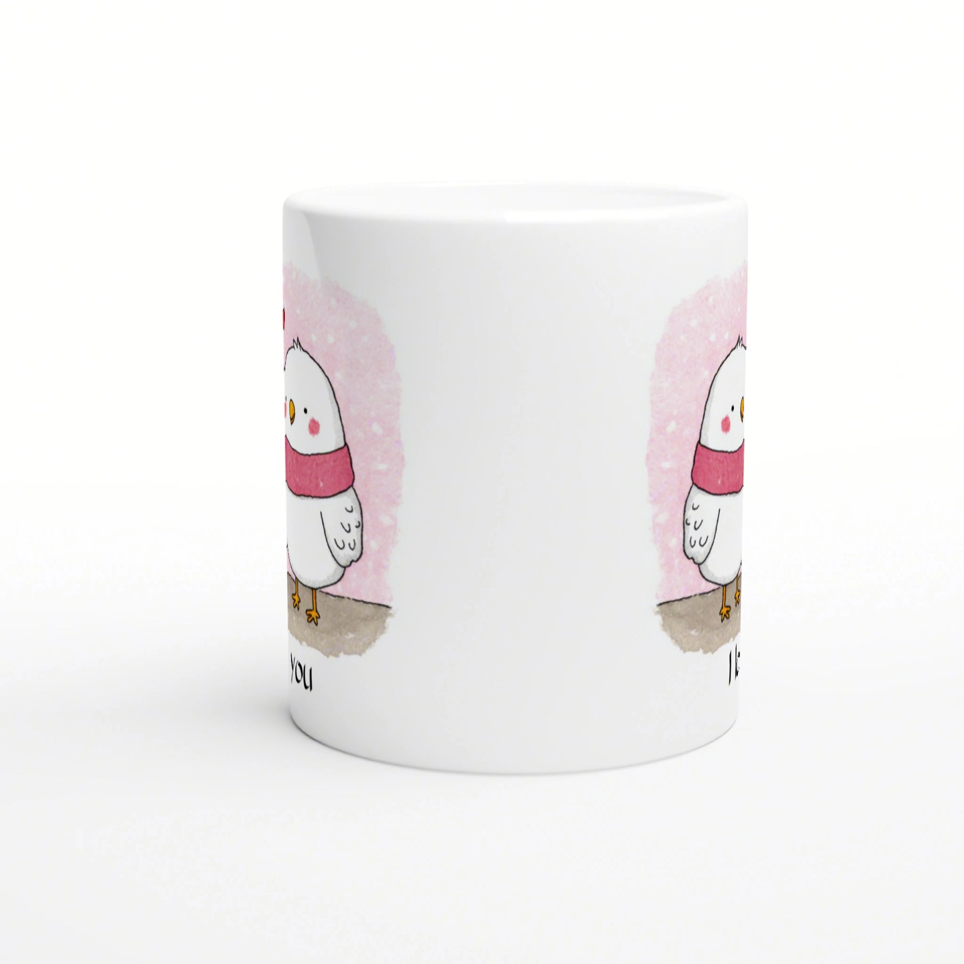 White mug featuring a cute chick wearing a pink scarf against a pink watercolor backdrop; product mockup.