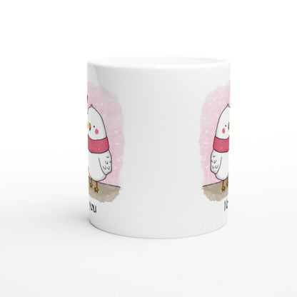 White mug featuring a cute chick wearing a pink scarf against a pink watercolor backdrop; product mockup.