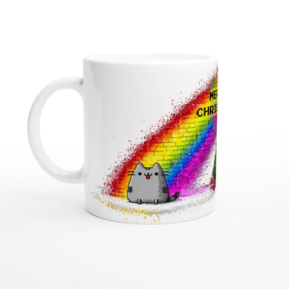 White mug mockup featuring a cute gray cat beneath a bright rainbow graffiti arc on a brick wall.