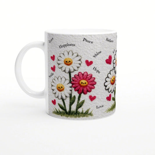White mug with daisies, yellow smiley centers, pink hearts, and words like Love, Happiness, Peace.