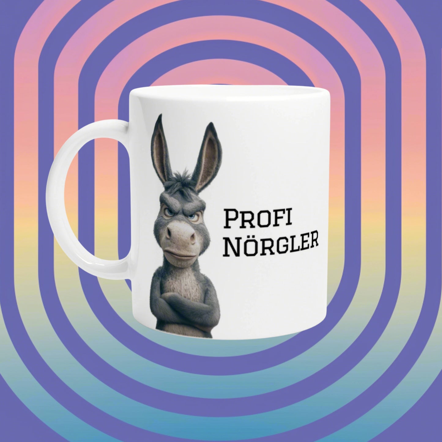 White mug mockup with a gray donkey and the text PROFI NÖRGLER; bright rainbow-arc background.