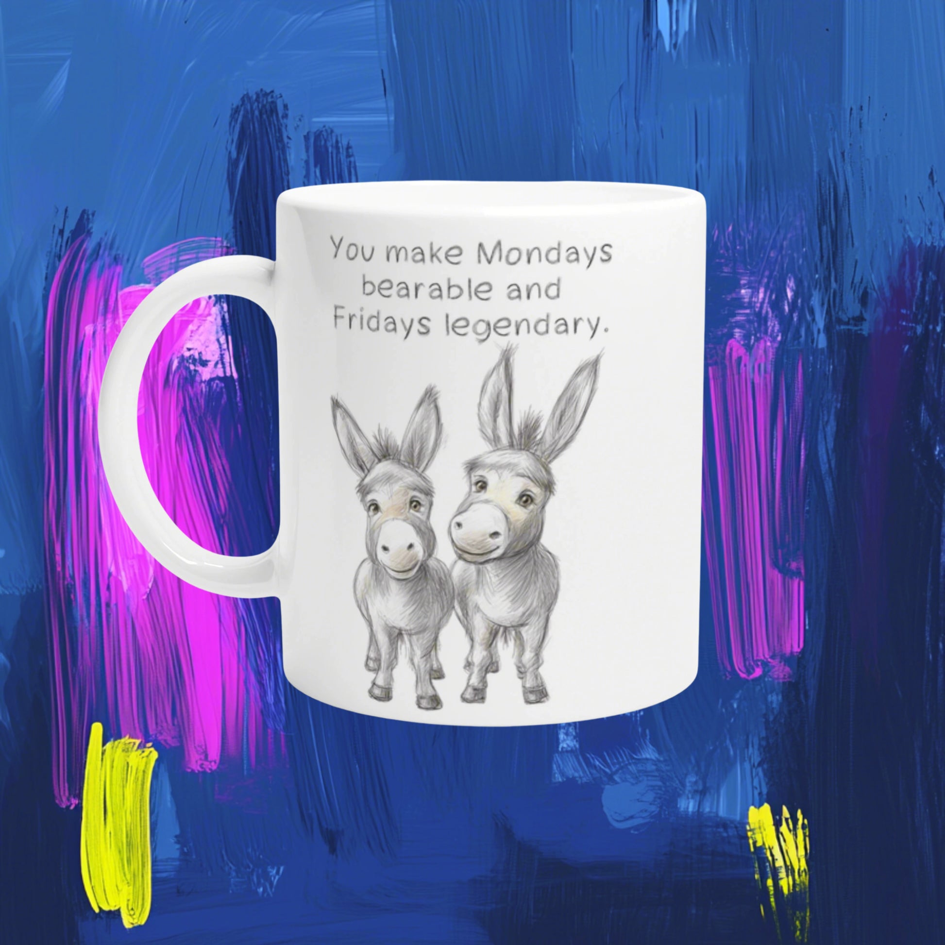 White mug with a pencil sketch of two donkeys and the caption 'You make Mondays bearable and Fridays legendary' — mockup.