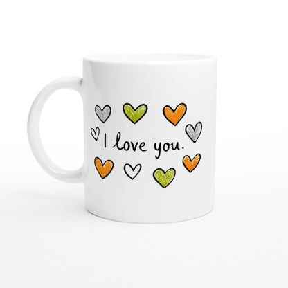 White mug featuring hand-drawn orange, green, and gray hearts around the phrase 'I love you'.