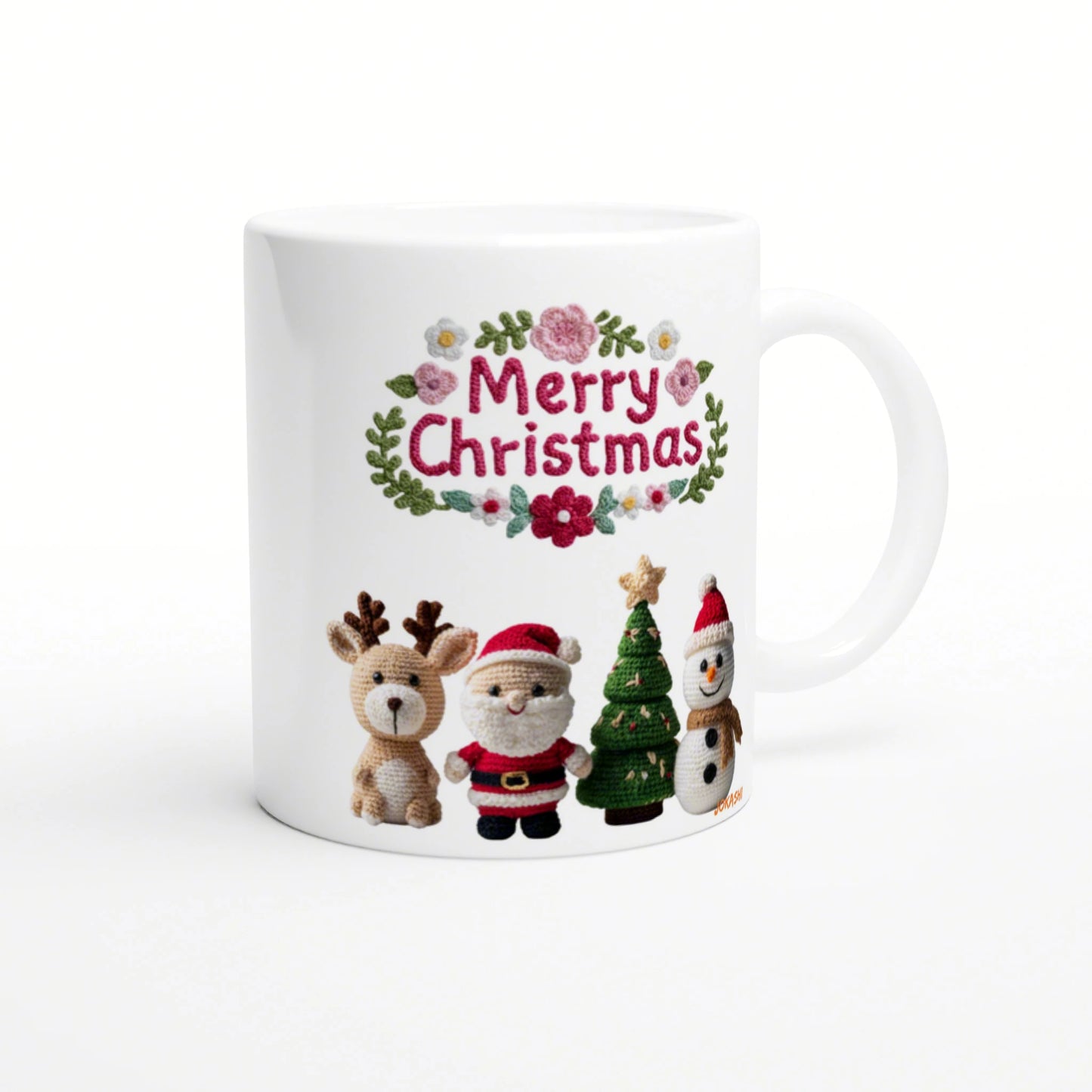 White mug with an embroidered 'Merry Christmas' design, featuring a floral border and crocheted reindeer, Santa, Christmas tree, and snowman.