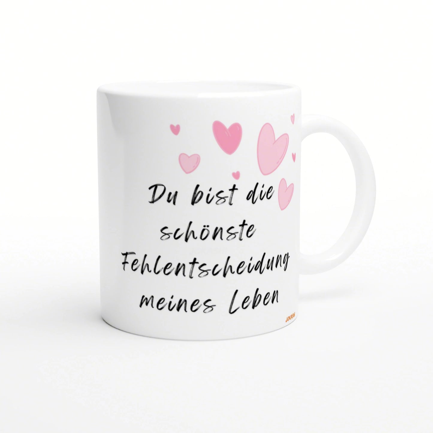 White mug with black cursive German quote 'Du bist die schönste Fehlentscheidung meines Lebens' and pink heart illustrations.