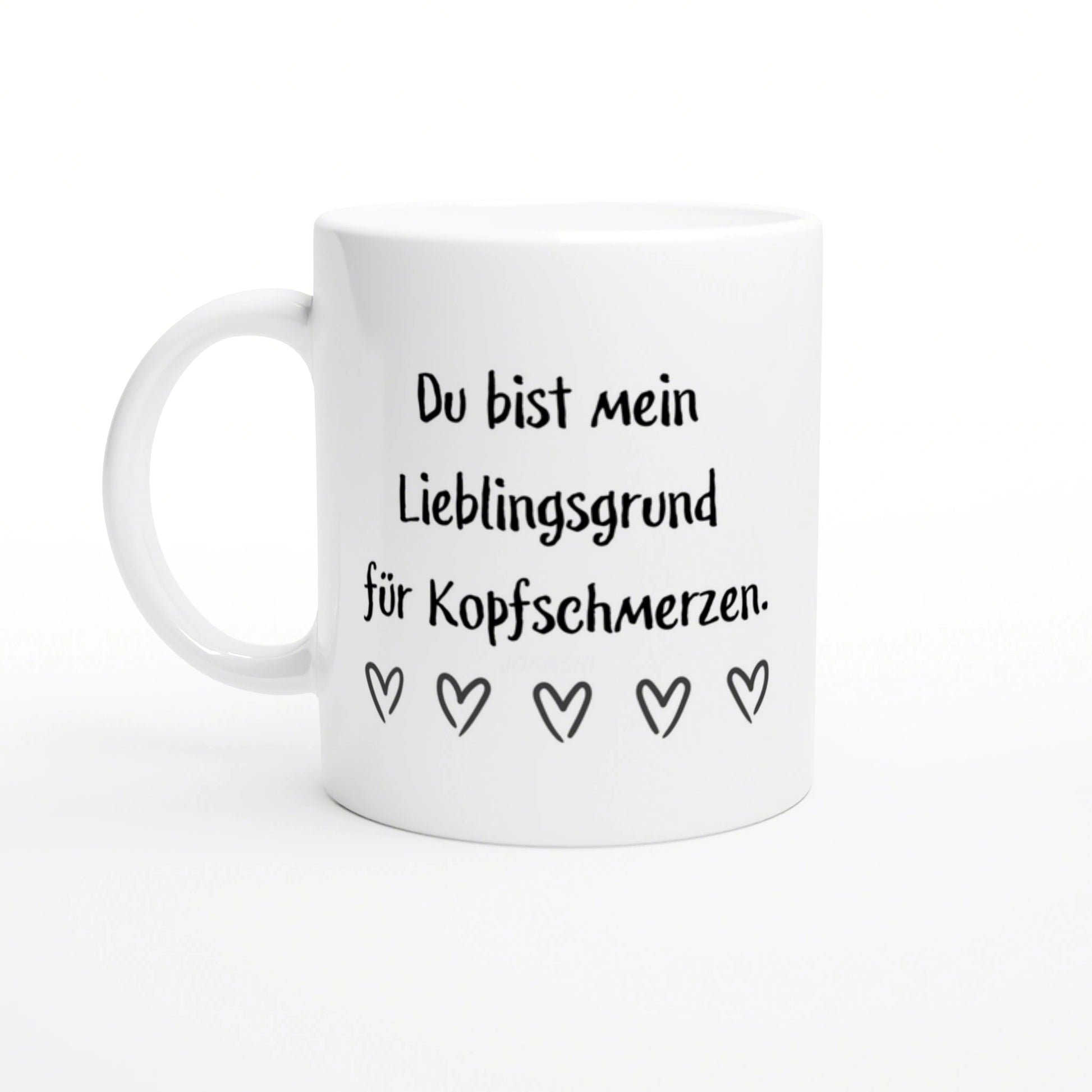 White ceramic mug mockup with black German text 'Du bist mein Lieblingsgrund fuer Kopfschmerzen' and five outlined hearts.