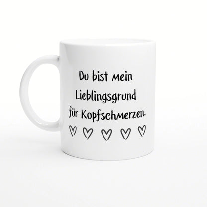 White ceramic mug mockup with black German text 'Du bist mein Lieblingsgrund fuer Kopfschmerzen' and five outlined hearts.