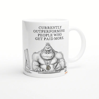 White mug featuring a gorilla sketch at a desk, wearing a medal, with 'Currently outperforming people who get paid more'.