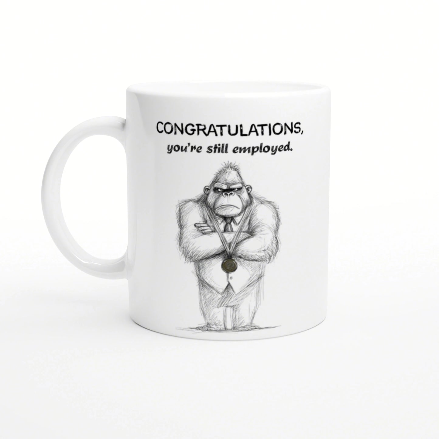 White mug featuring a hand-drawn gorilla in a suit with a medal and the caption Congratulations, you're still employed