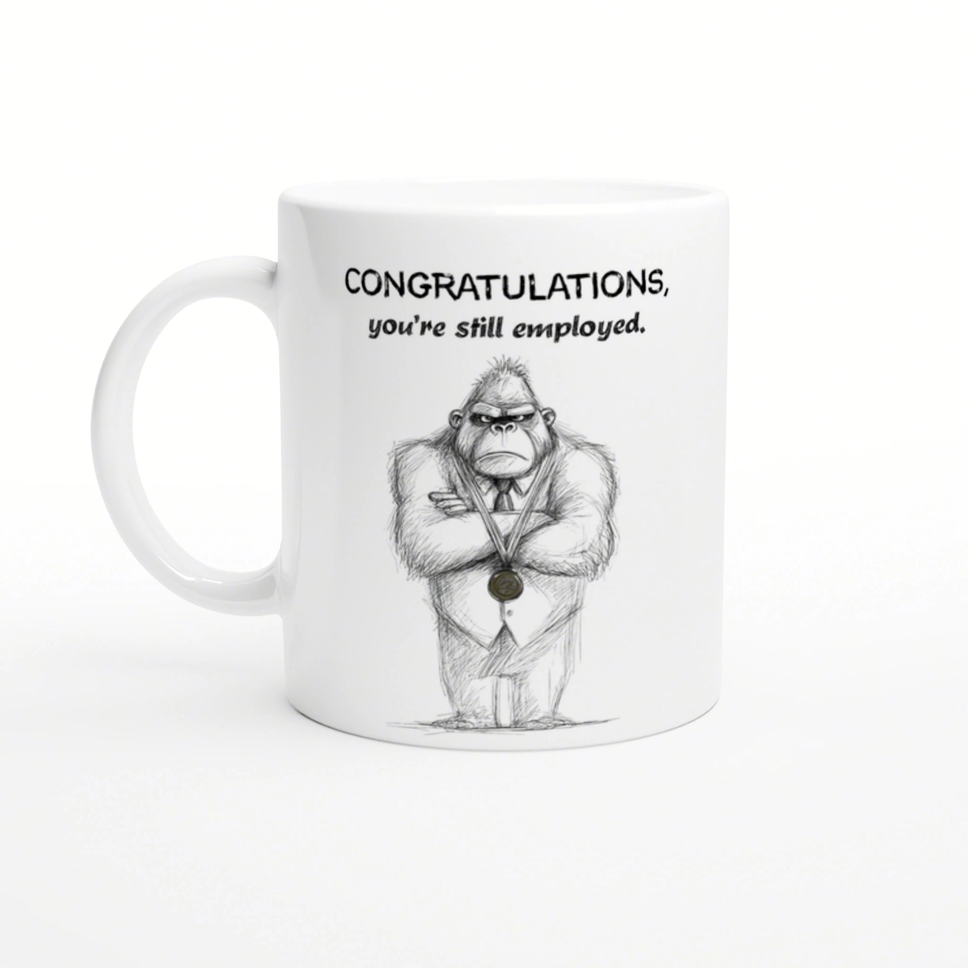 White mug featuring a hand-drawn gorilla in a suit with a medal and the caption Congratulations, you're still employed