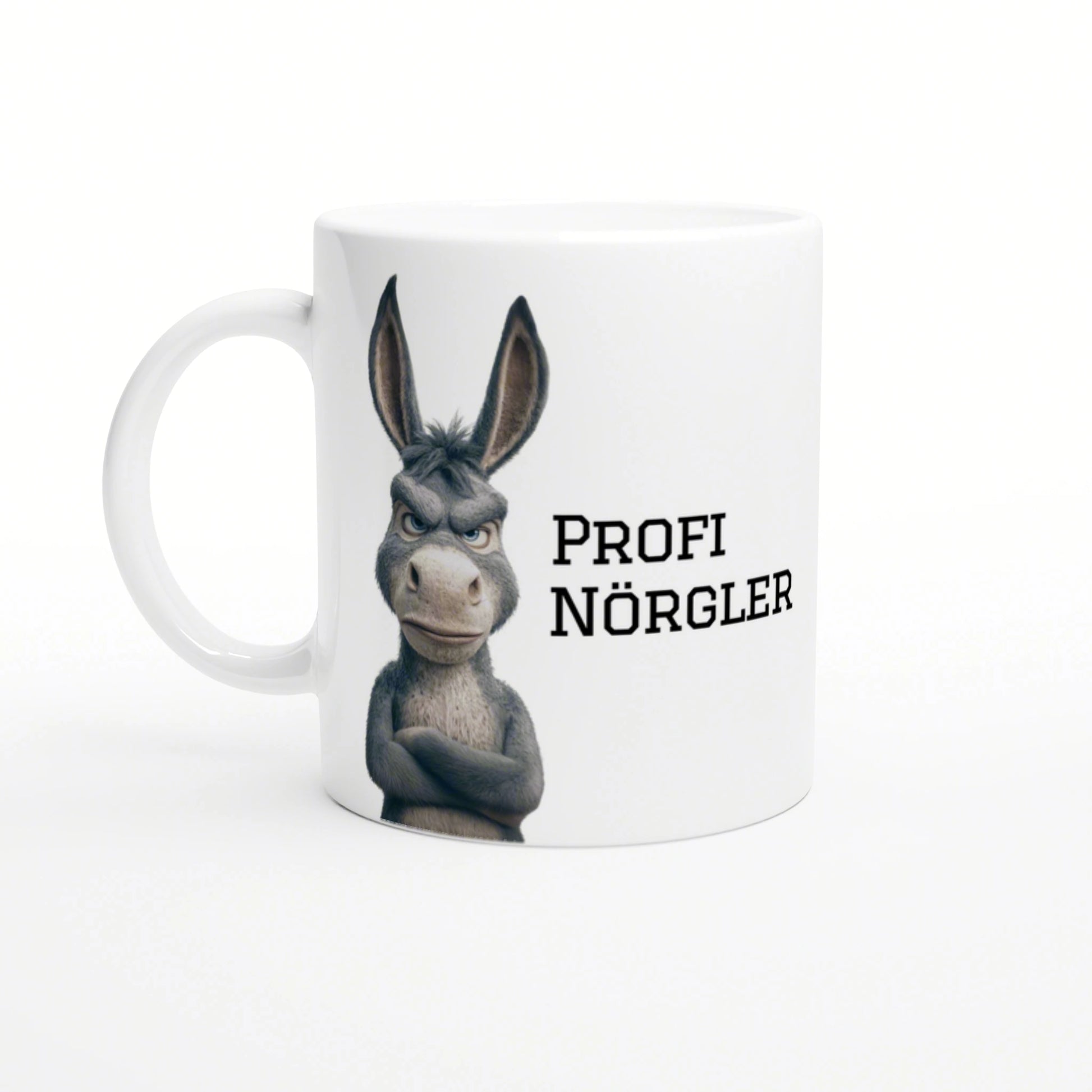 White mug featuring a grumpy cartoon donkey with crossed arms and the text PROFI NÖRGLER.