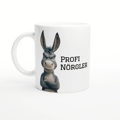 White mug featuring a grumpy cartoon donkey with crossed arms and the text PROFI NÖRGLER.