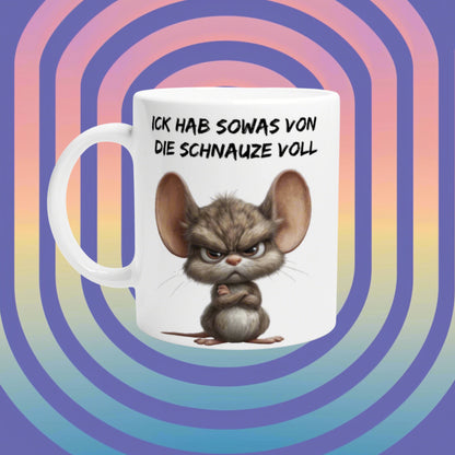 White mug with a grumpy cartoon mouse, folded arms, and the slogan Ick hab sowas von die Schnauze voll on a rainbow backdrop.