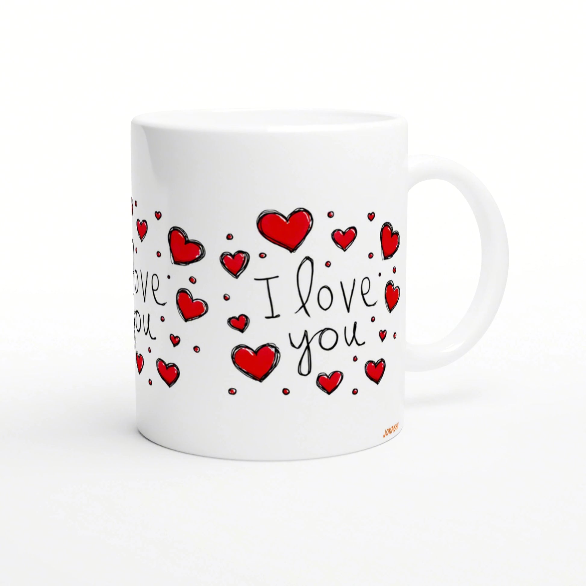 White ceramic mug with hand-drawn red hearts and the words I love you in black script; product mockup for an online shop.