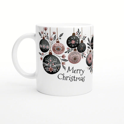 White mug featuring hanging Christmas ornaments in black and pink, with the words Merry Christmas.