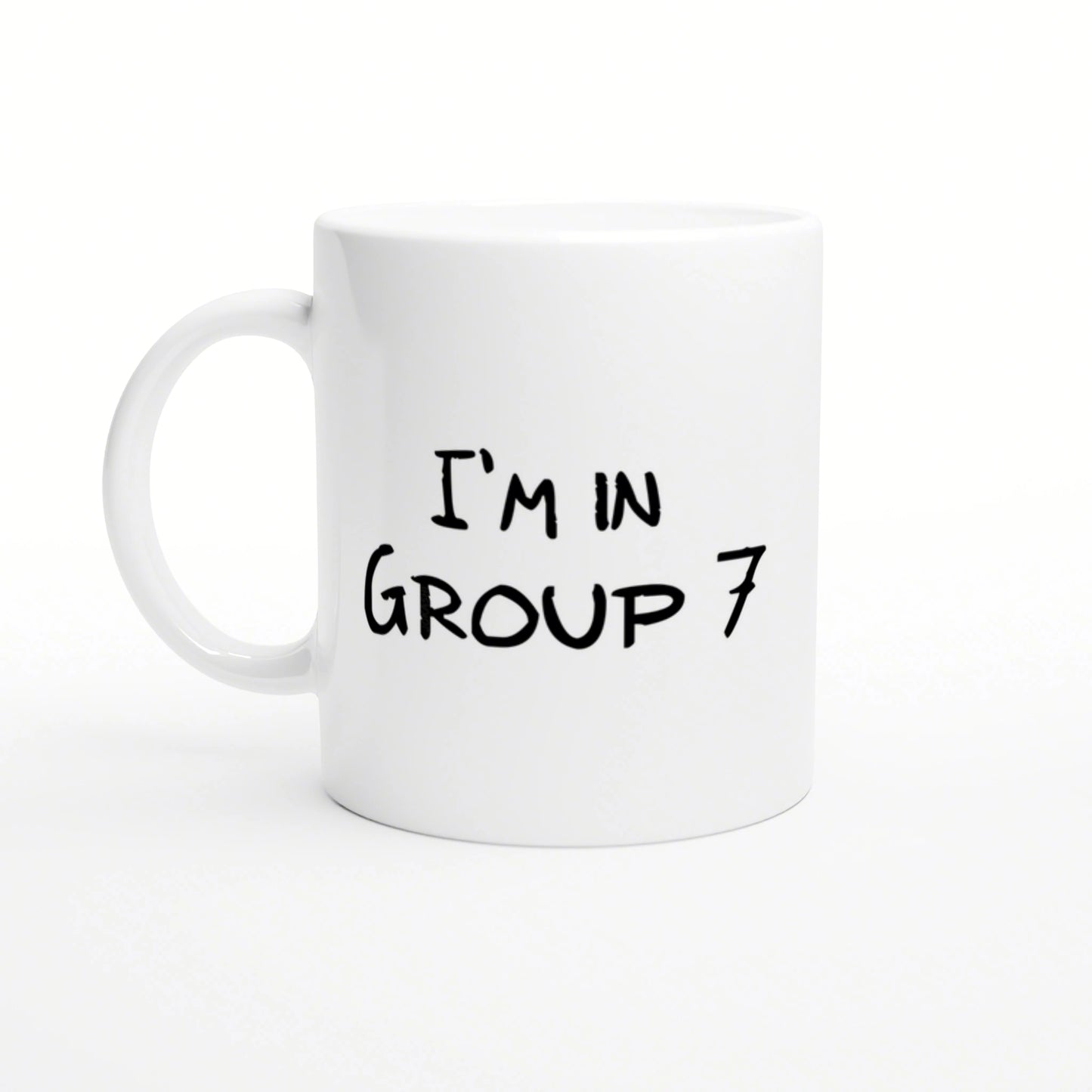 White ceramic mug featuring black handwritten text 'I'M IN GROUP 7'.