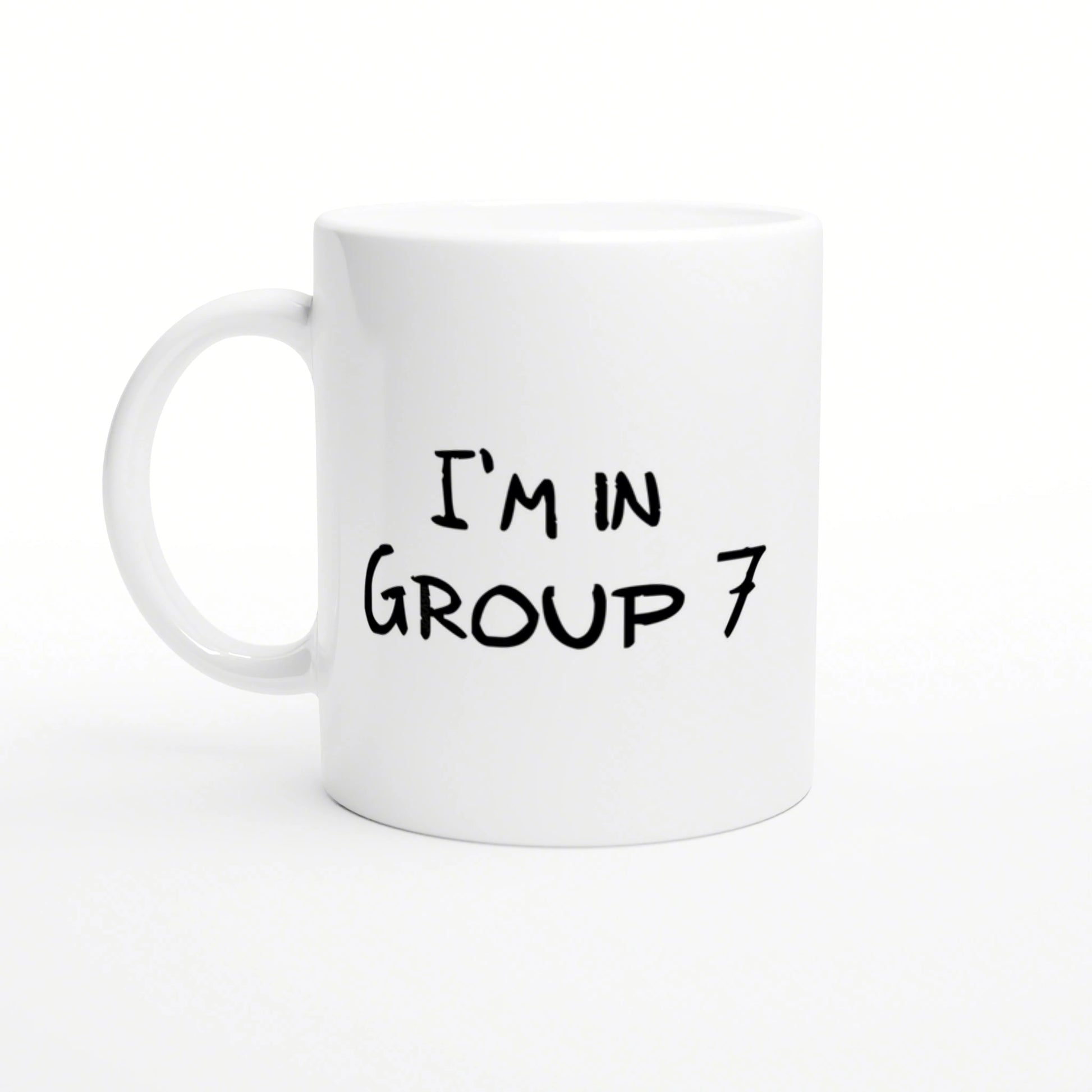 White ceramic mug featuring black handwritten text 'I'M IN GROUP 7'.