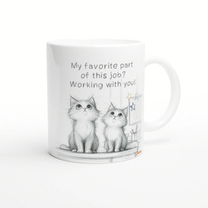 White mug featuring a pencil sketch of two kittens and the caption 'My favorite part of this job? Working with you!'
