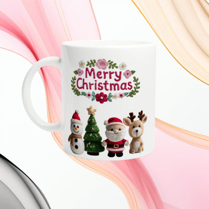 White mug with knitted Christmas design: Merry Christmas text, plus a snowman, Christmas tree, Santa and a reindeer.