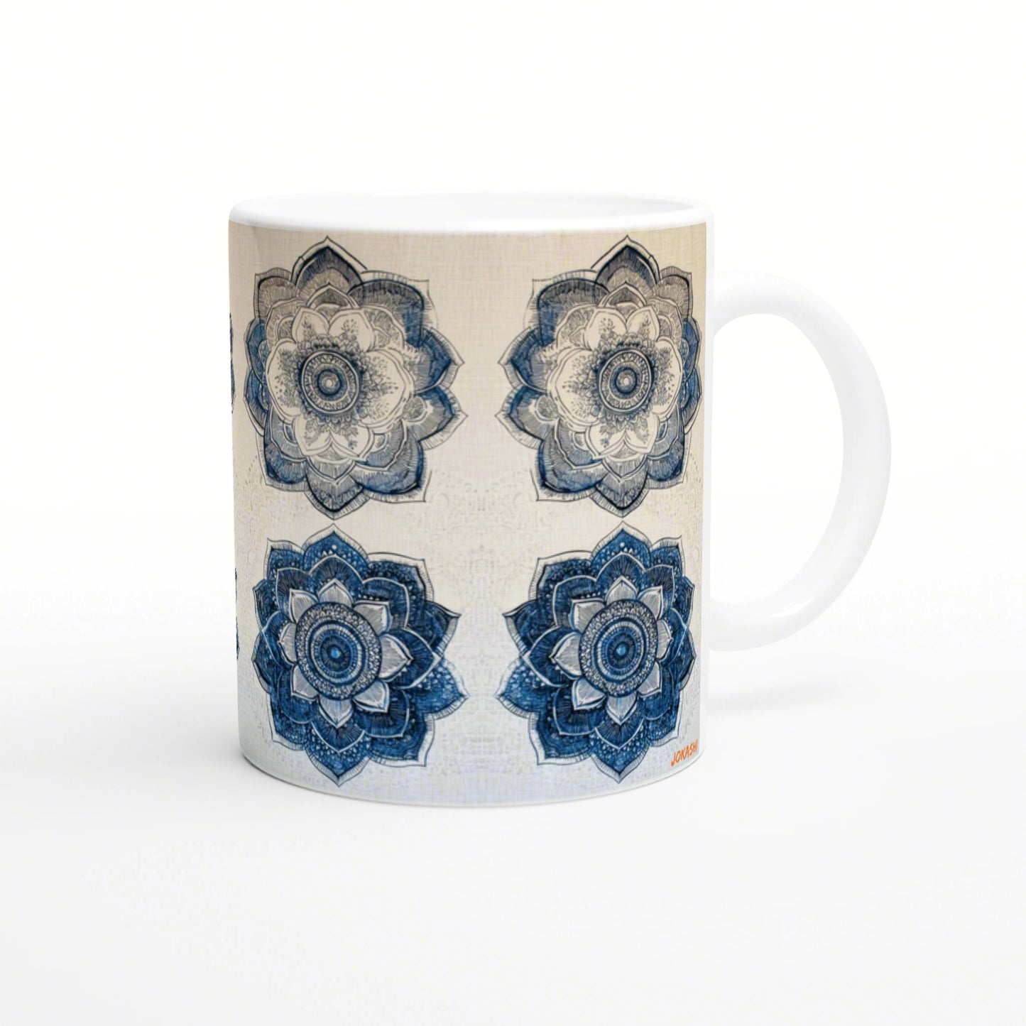 White mug adorned with four mandala flowers in blue and beige, arranged in a grid; product mockup.