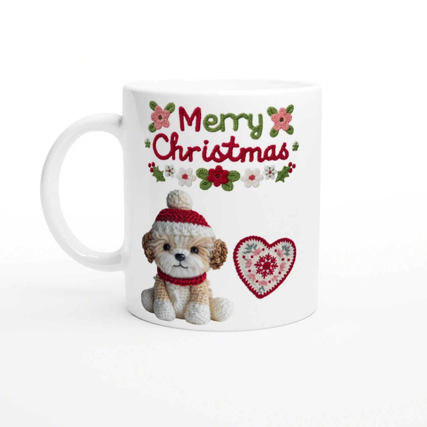 White mug with 'Merry Christmas' knitted text, a crocheted puppy in a red hat and scarf, and a heart motif.