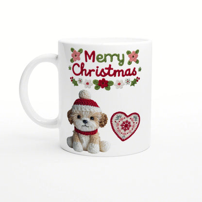 White mug with 'Merry Christmas' knitted text, a crocheted puppy in a red hat and scarf, and a heart motif.