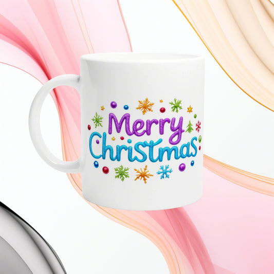 White ceramic mug featuring a colorful Merry Christmas design with snowflakes, against flowing pink and peach ribbons.