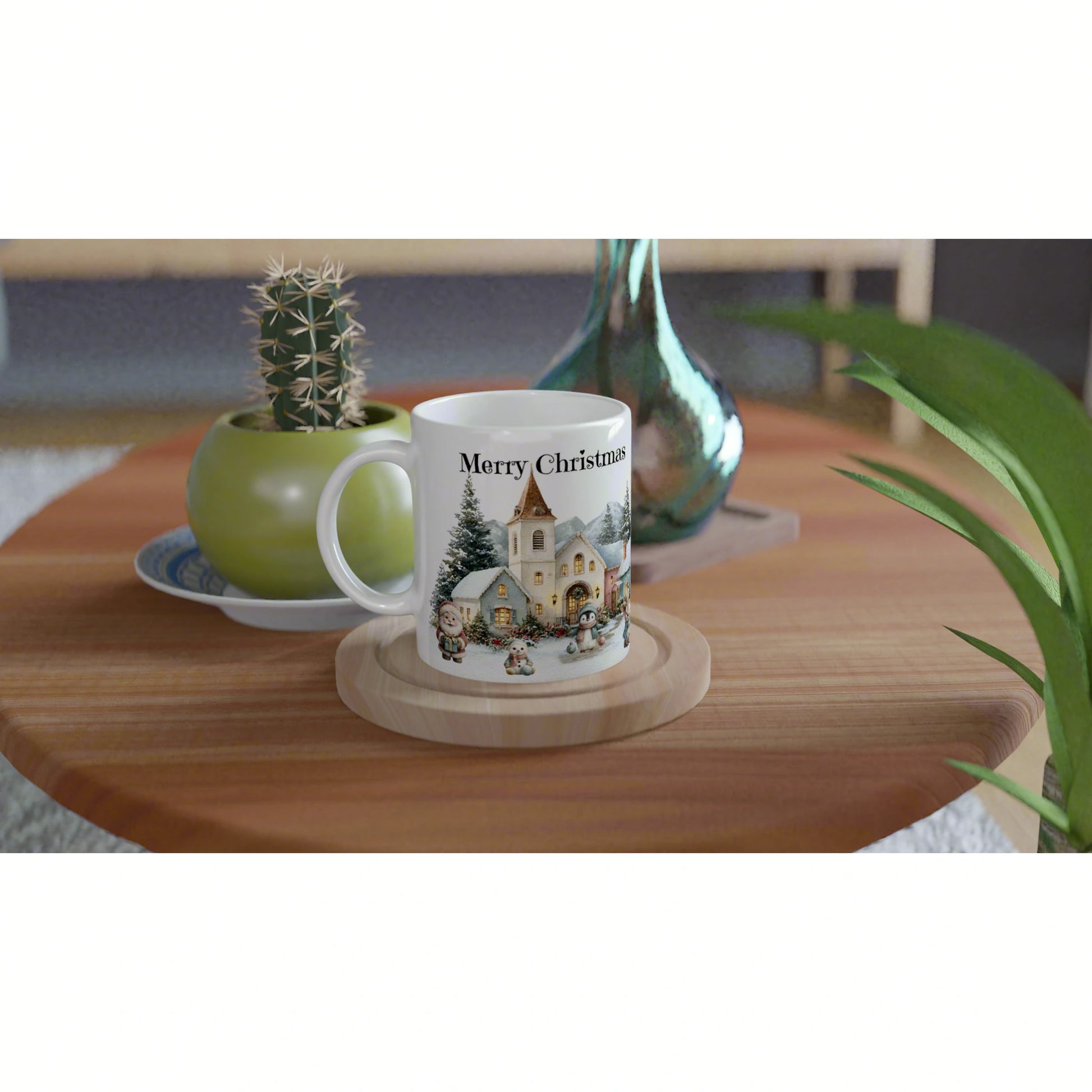 White mug featuring a Christmas village illustration and the words Merry Christmas, on a wooden coaster on a tabletop with plants.