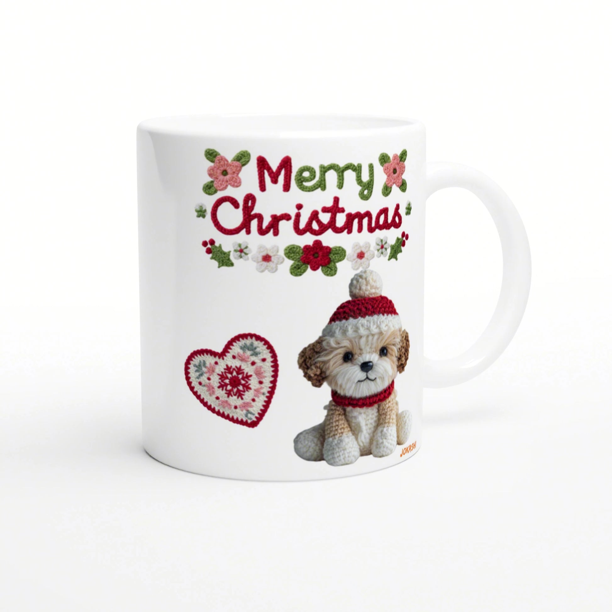White mug mockup featuring a crocheted puppy in a red hat and scarf, Merry Christmas text with holly and a knitted heart motif.