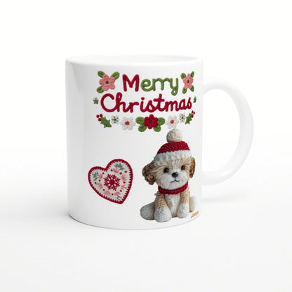 White mug mockup featuring a crocheted puppy in a red hat and scarf, Merry Christmas text with holly and a knitted heart motif.