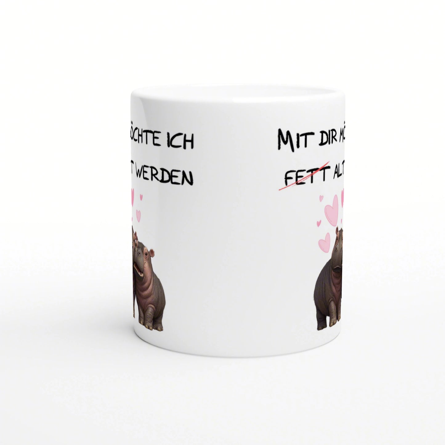 White mug mockup featuring black handwritten German slogans, cartoon hippos on both sides, and pink hearts.
