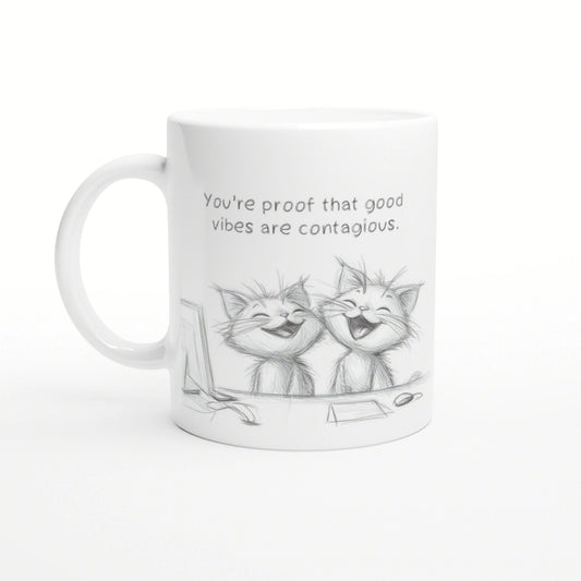 White mug mockup featuring a pencil sketch of two laughing cats and the slogan 'You're proof that good vibes are contagious.'