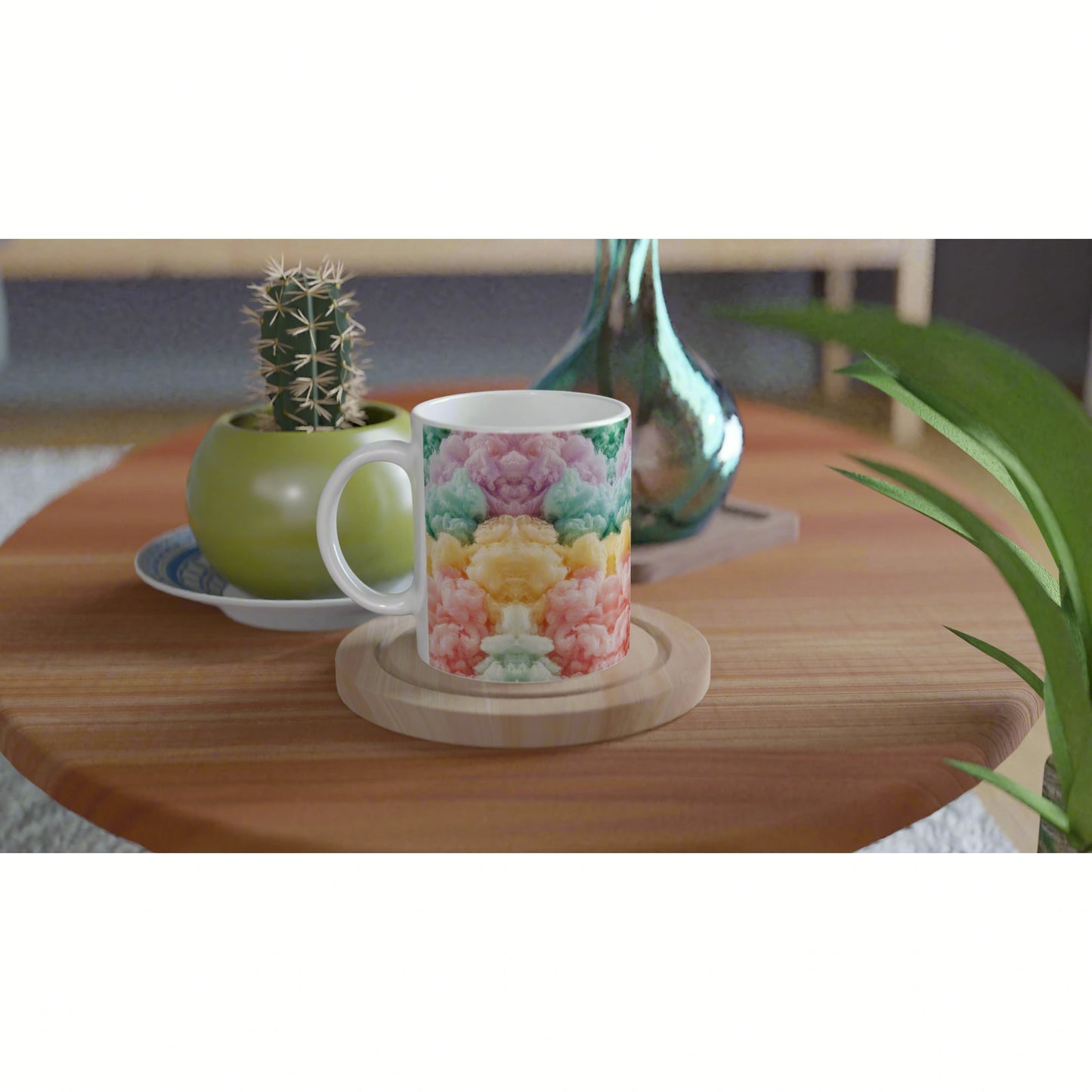 White mug with pastel cloud pattern sits on a wooden coaster on a wooden table, with a green cactus pot and a blue glass vase in the background.
