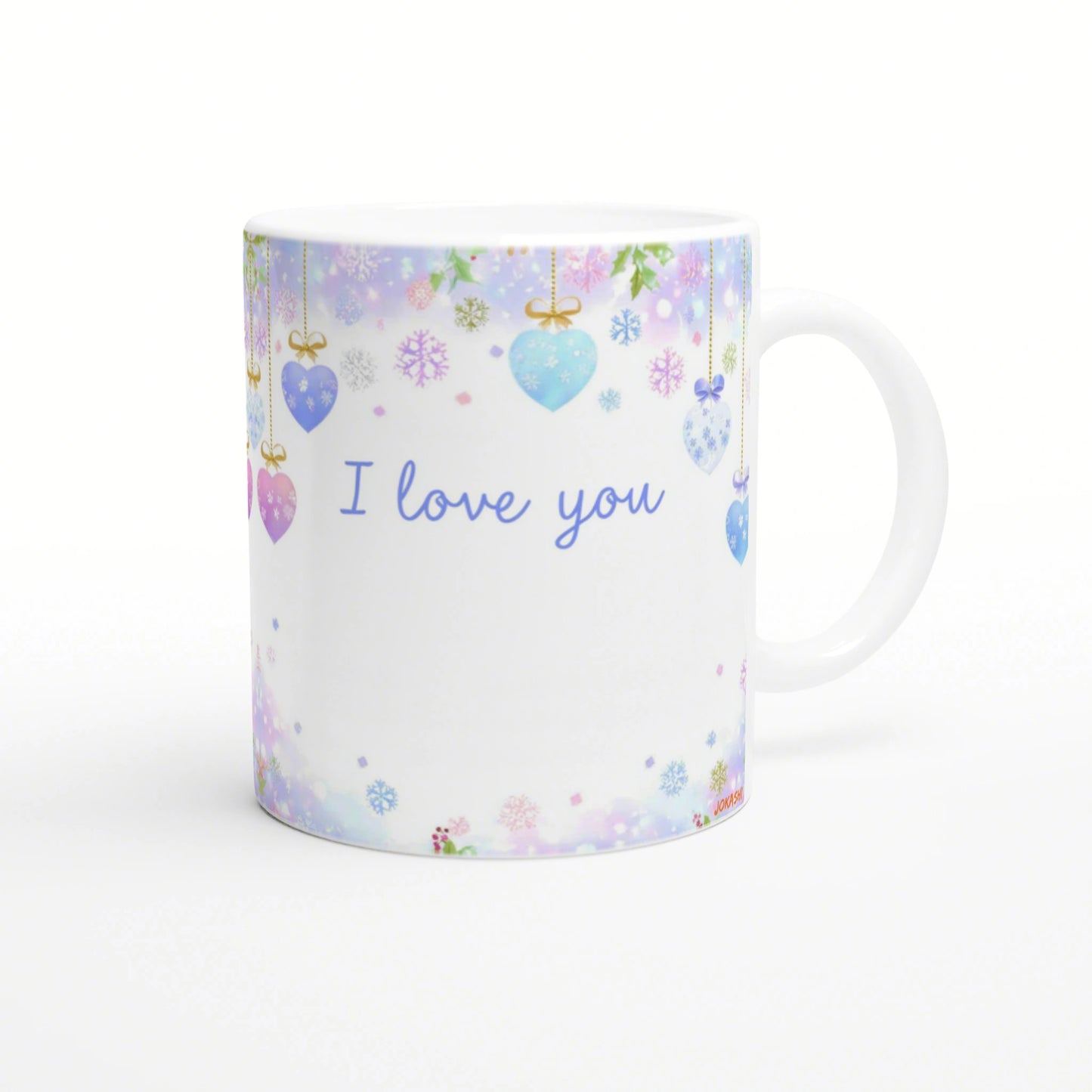 White mug mockup adorned with pastel hanging hearts and snowflakes; blue I love you text across the front.
